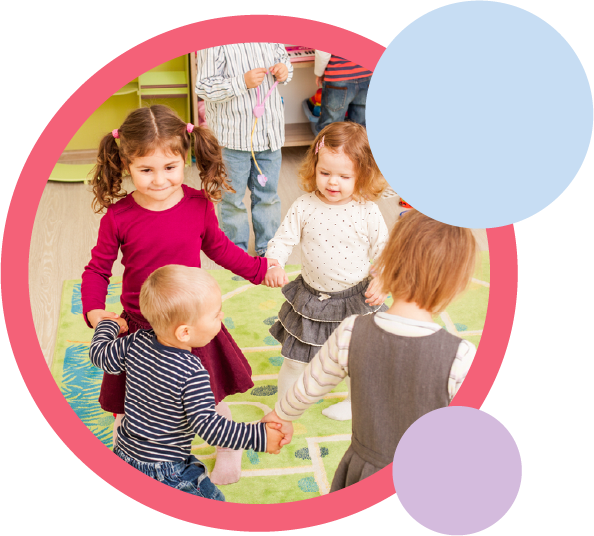 Preschool-age children holding hands in a circle playing.